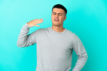 Young handsome man over isolated blue background with tired and sick expression