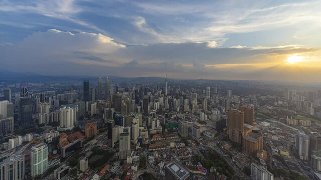 Aerial day-time time lapse overlooking a wide view of a city skyline with dancing rays before sunset in Kuala Lumpur, Malaysia. Prores 4K DCI