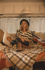 Hippie Boho girl with guitar in trailer, rest relaxing vibe