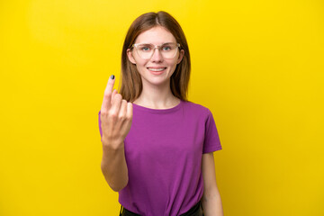 Fototapeta premium Young English woman isolated on yellow background doing coming gesture