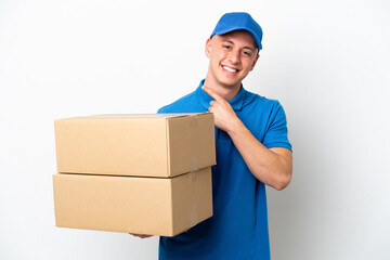 Young delivery Brazilian man isolated ops white background pointing to the side to present a product