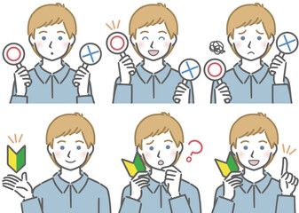 〇✕マークや初心者マークを持つ、若い白人男性