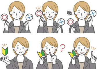 〇✕マークや初心者マークを持つ、スーツを着た中年の白人女性