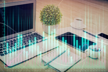 Financial market graph hologram and personal computer on background. Double exposure. Concept of forex.