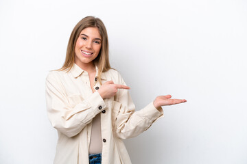 Young caucasian woman isolated on white bakcground holding copyspace imaginary on the palm to insert an ad