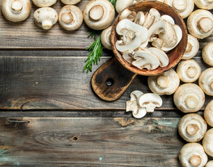Pieces of fragrant mushrooms in bowl on cutting Board