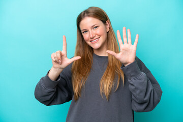 Young caucasian woman isolated on blue background counting seven with fingers