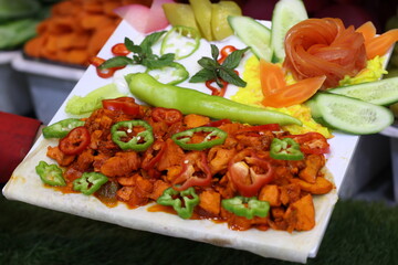 Hand Holding Serving Plate of Mexicano Dish Garnished with Toppings and Dressings  Meat Dishes Stock Photos