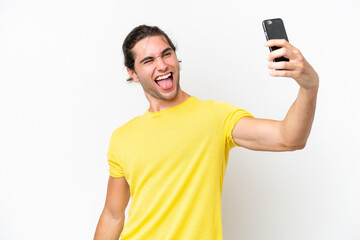 Caucasian handsome man isolated on white background making a selfie