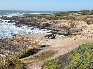 Park bench on bluff near the shore
