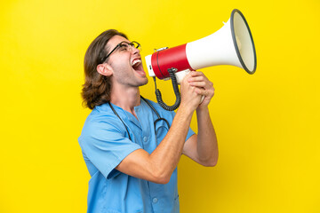 Young surgeon caucasian man isolated on yellow background shouting through a megaphone