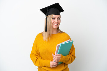 Young student caucasian woman isolated on white background looking to the side and smiling