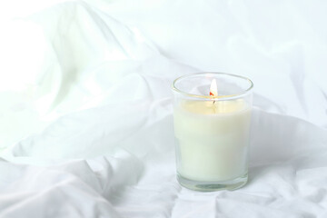 Luxury Cozy candle in jar with white fabric background, Dry reeds boho style. Burning scented candle, Handmade wax candle, High quality photo, valentine romance concept