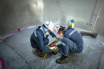 Male worker inspection vacuum test weld tank stainless steel