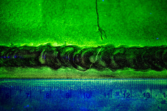 Crack steel butt weld carbon background green contrast magnetic filed fluorescent test