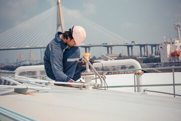 Male worker are ultrasonic thickness roof of  storage tank