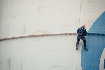 Male worker rope access  inspection of thickness  storage tank