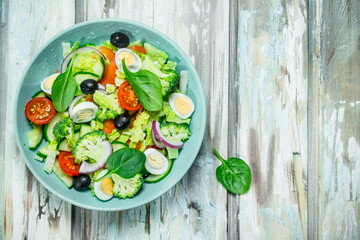 Vegetable salad. Salad of tomatoes, cucumbers and quail eggs with olive oil.