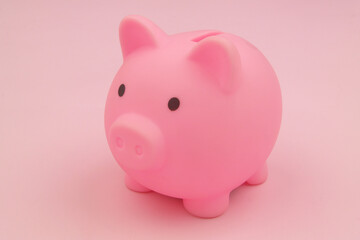 Close up of piggy bank on pink background.