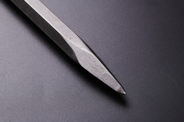 Metal chisel for concrete for perforator isolated on black background
