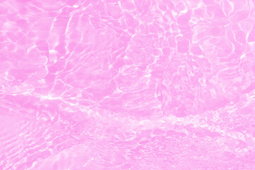 Defocus blurred transparent pink colored clear calm water surface texture with splashes and bubbles. Trendy abstract nature background. Water waves in sunlight with copy space. Pink water shining.