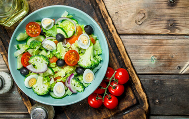 Vegetable salad. Tomato, cucumber and quail egg salad with olive oil and Basil.