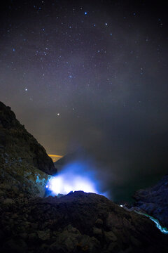 Blue flames of molten sulfur burning at the mine inside the crater of Kawah Ijen volcano, Banyuwangi, Java, Indonesia