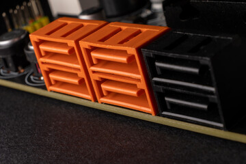 SATA connectors on the computer motherboard of sata3 and sata6 types marked by orange and black colours - 561245987