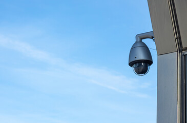 Videcam on the facade of the building against the blue sky