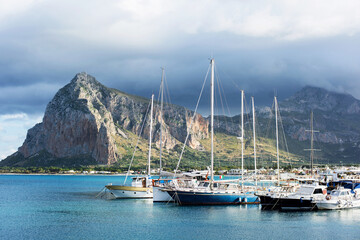 Fototapeta na wymiar Sailing boats in the port of San Vito Lo Capo town, Sicily island, Italy. Popular travel destination