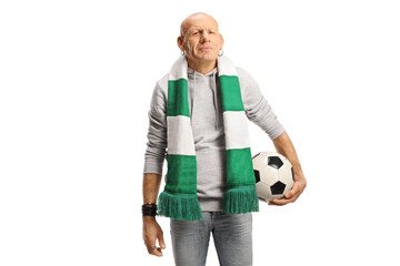 Man wearing a green and white scarf and holding a football
