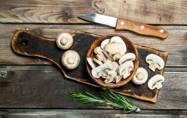 Pieces of fragrant mushrooms in bowl on cutting Board
