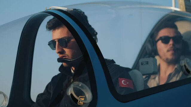 Captain and passenger in a cockpit operating the plane. small private jet. helicopter. 4k uhd 