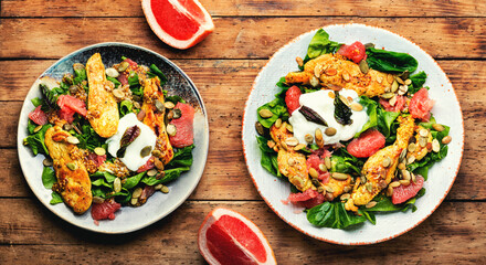 Fresh salad with grilled chicken breast, herbs and fruits