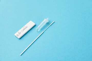 Home Antigen Test Kit virus covid-19 negative and positive, blue background, copy space