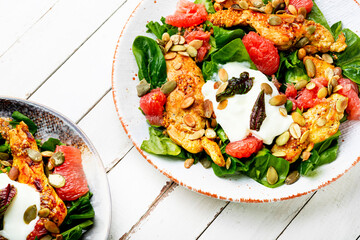 Chicken salad with meat, lettuce and fruits