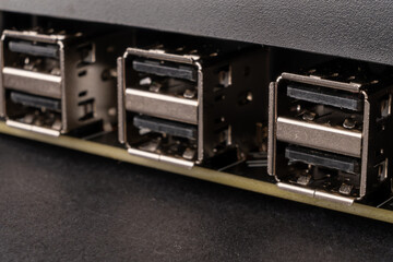 An image of USB connectors on a computer motherboard backplate, arranged in a row of USB Type 2 , ready for connecting devices - 561254302