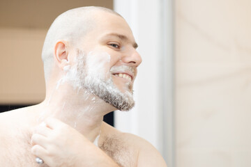 a man shaves his beard, men's cosmetics and care skin, shaving foam