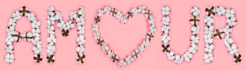 Word amour from french language means love, made of cotton flowers. Concept of organic candid true love. Letter made in shape of heart of cotton bud. Pink background