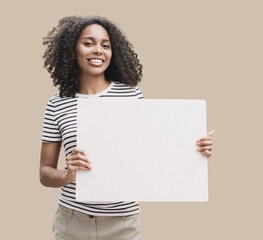 Happy young woman holding blank white banner sign, isolated studio portrait