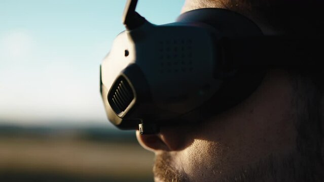 Man with virtual reality goggle drive the fpv drone close-up