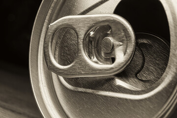 A macro image of an open beer or soda can with a silver pull ring, representing the moment of relaxation and indulgence - 561258578
