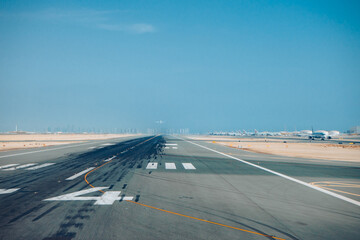 Fototapeta na wymiar Looking down the runway at Abu Dhabi waiting for take off.