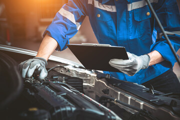 Car care maintenance and servicing, Hand technician auto mechanic checking inspection list after fix or repairing change spare part car engine problem and car insurance service support assistance.