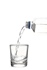 pouring water in glass, white background. clear sparkling water