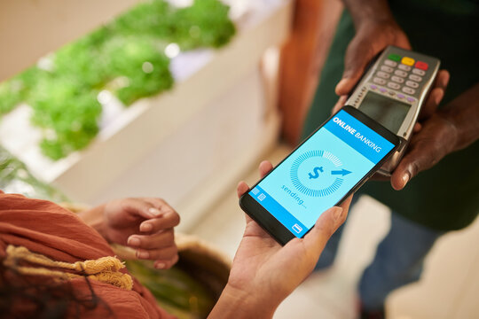 Closeup image of customer paying for purchases with mobile application