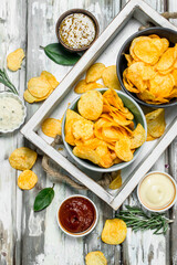 Potato chips with different sauces.