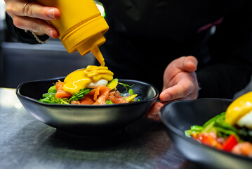 Chef in restaurant kitchen cooking salad