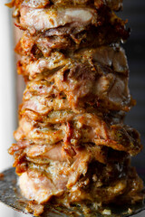 Man cutting prepared meat for Shawarma