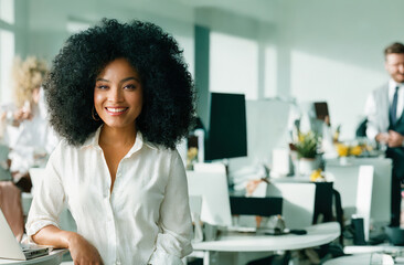 Confident black businesswoman smiling while standing at office